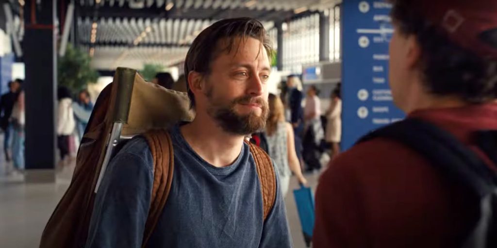 David and Benji meet in an airport. Benji has a large backpack.