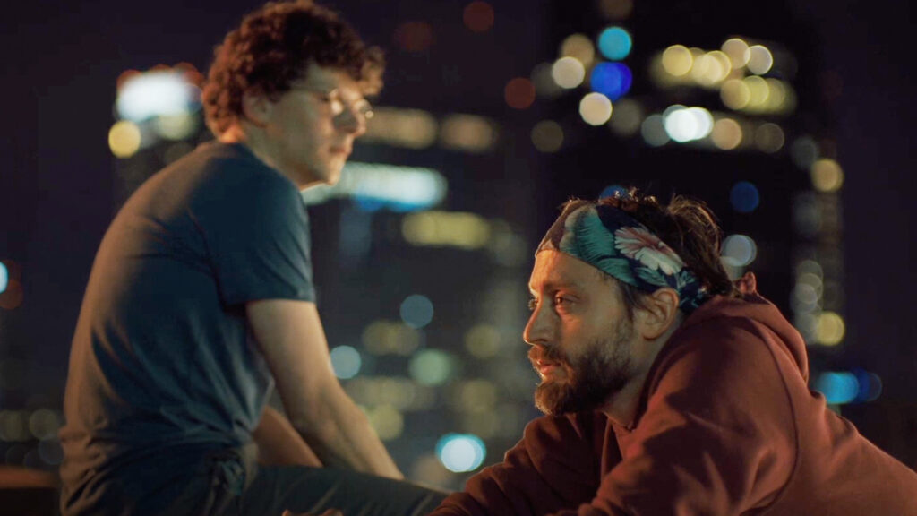 David and Benji are sitting on a rooftop at night.