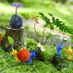 A group of all variety of pikmin sitting in the grass and carrying a raspberry.