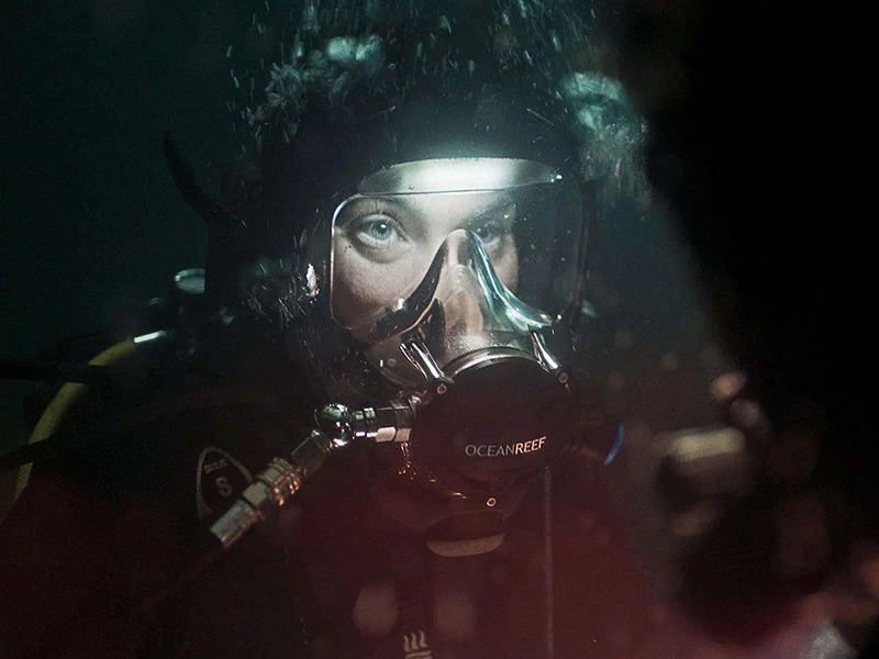 A person underwater in a scuba suit from The Last Breath