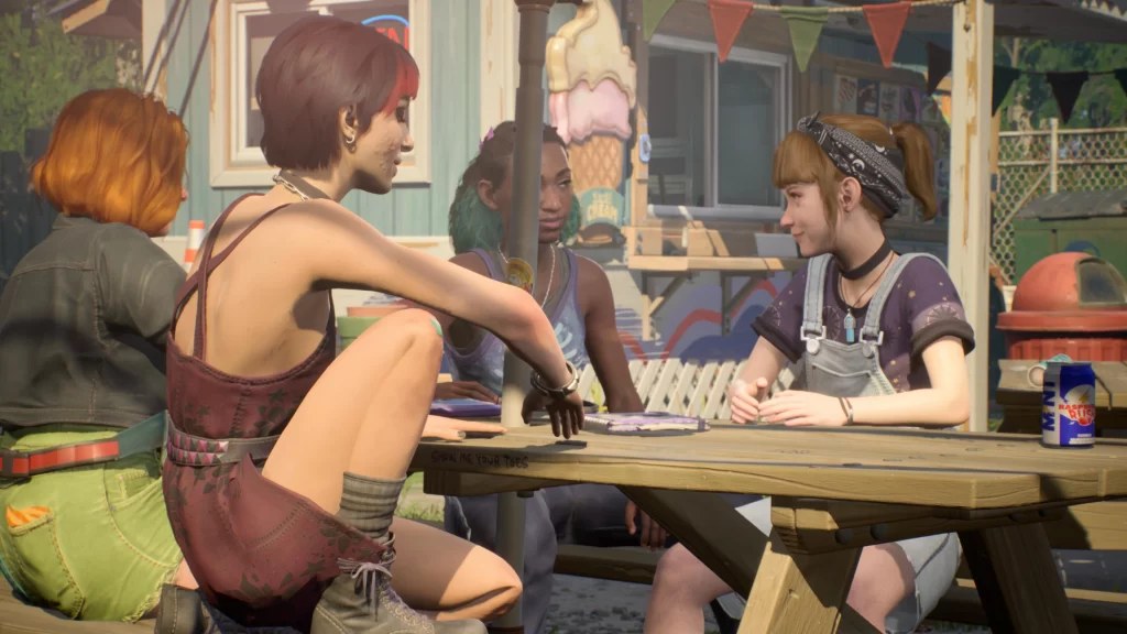 Three teenage girls sitting at a picnic table